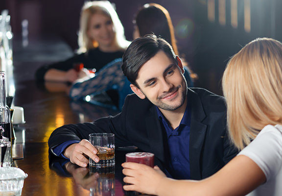 Young couple at a bar flirting