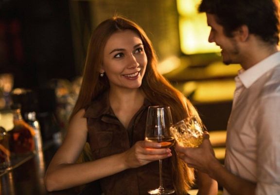 Man and Woman Flirting and Chatting at Bar