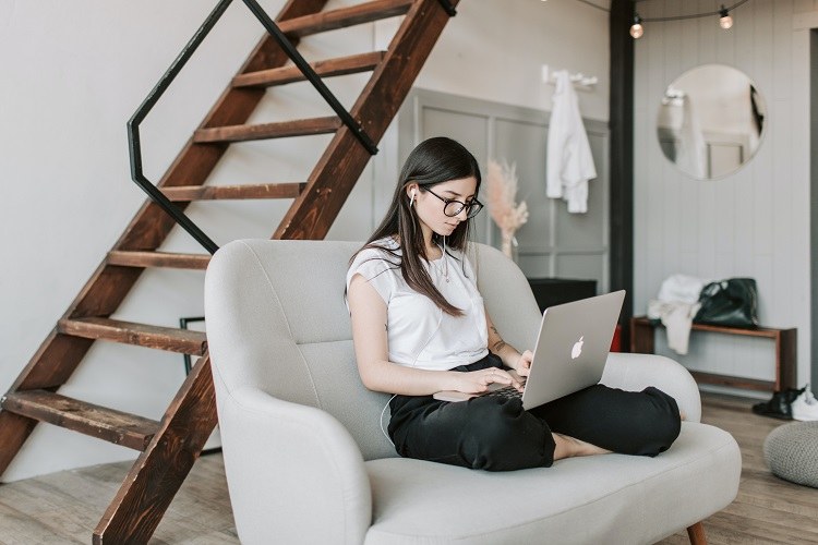 Woman on couch doing virtual speed dating